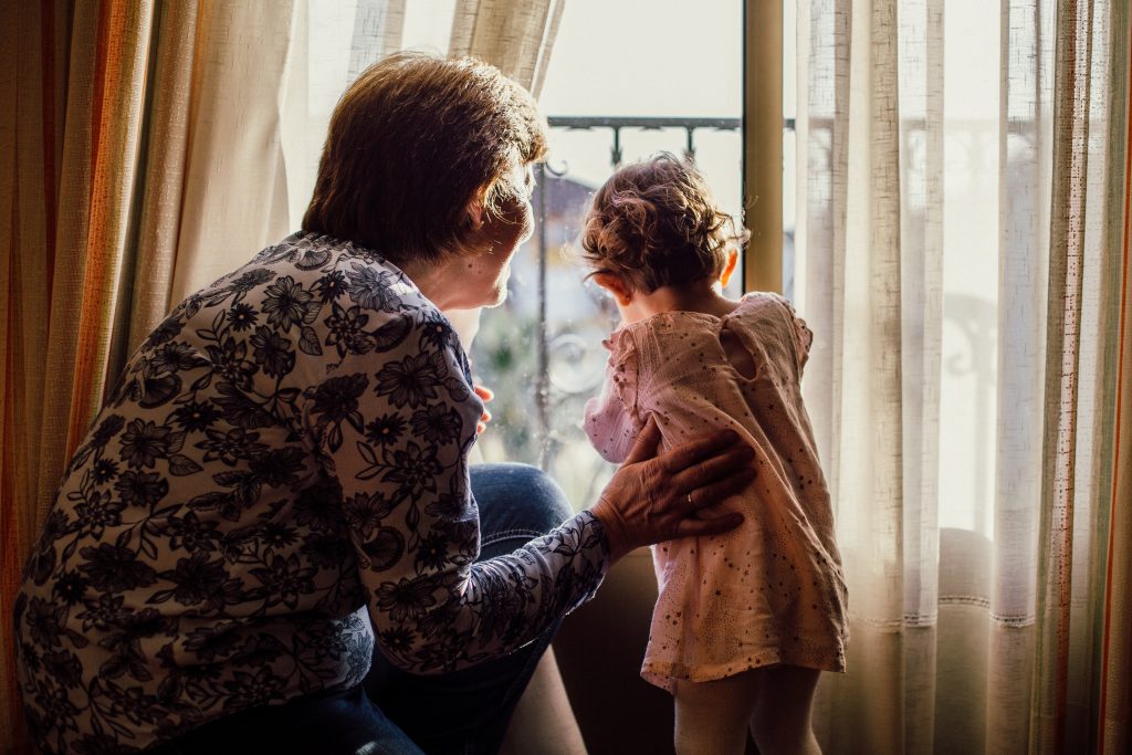 Lady at window with a child