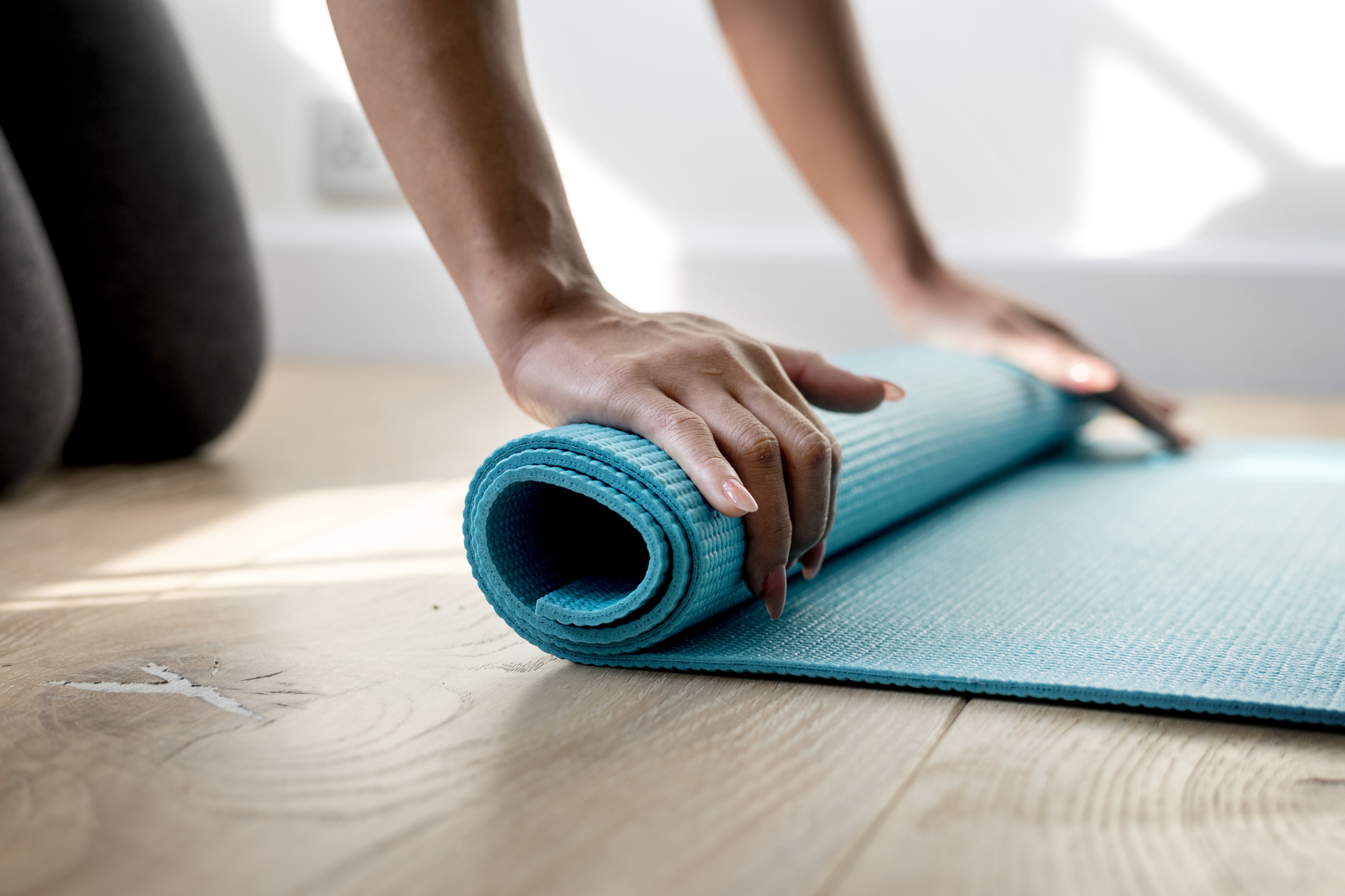 rolling out a workout mat