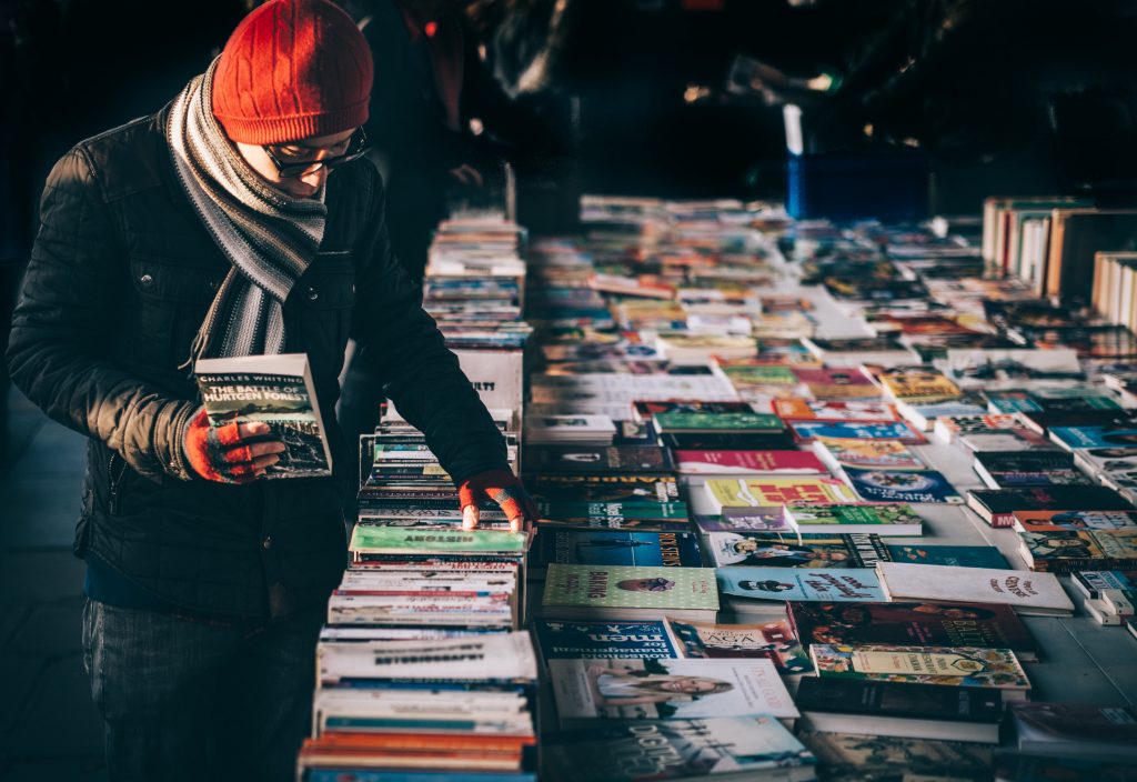 a man buying books at a book stall