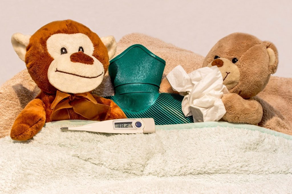 toys in bed with a thermometer