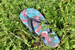 a blue flowery flip flop 