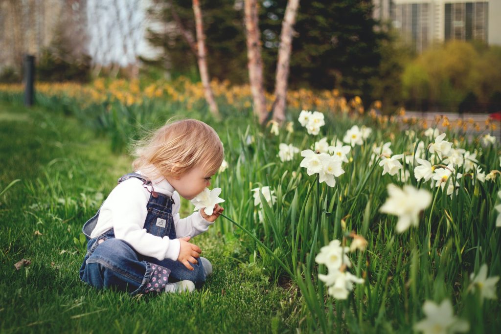 girl smelling flowers