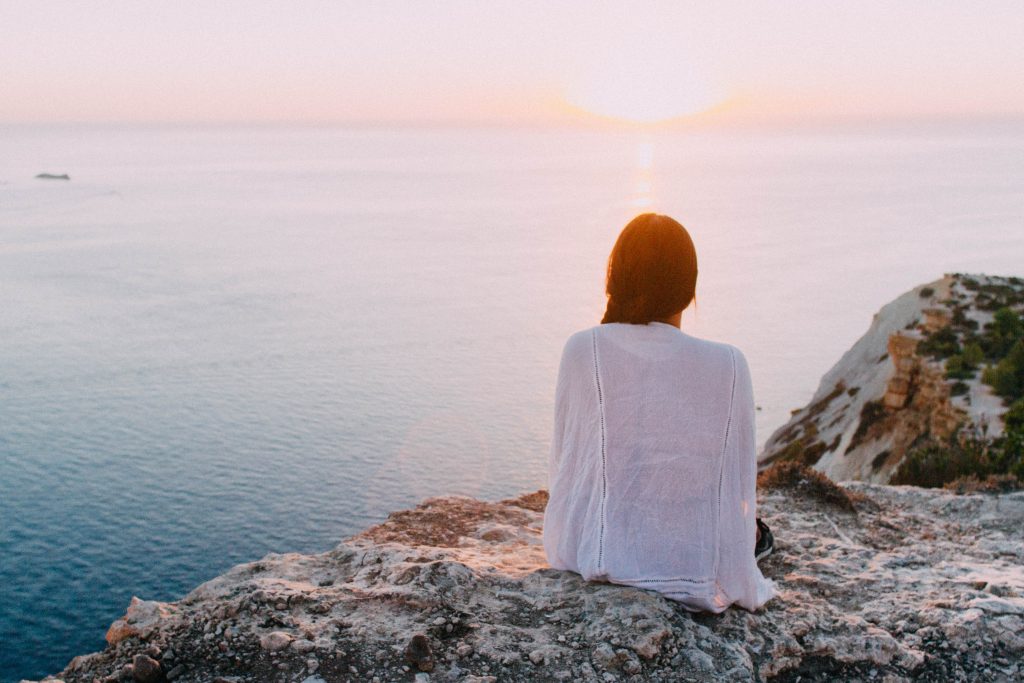 lady sitting by the sea 